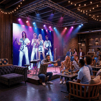 Pantalla LED de 3x2 m como fondo de escenario en un bar, con una banda musical en video y público sentado